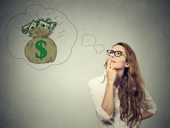 A woman thinking about money and investing, representing financial planning and investing basics in Canada.
