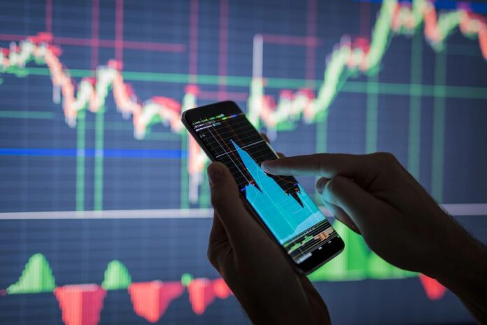Person trading cryptocurrency on a smartphone app in Canada, showing Bitcoin and Ethereum investments.
